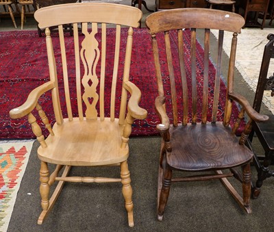 Lot 1375 - An early 20th century elm rocking chair with...