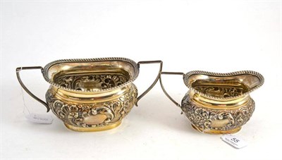 Lot 55 - Embossed silver cream and sugar bowl