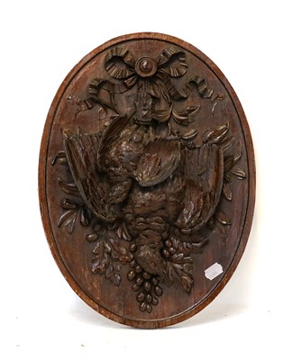 Lot 1389 - A Black Forest walnut ovoid wall plaque,...