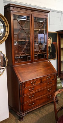 Lot 1318 - A George III style bureau bookcase, the...