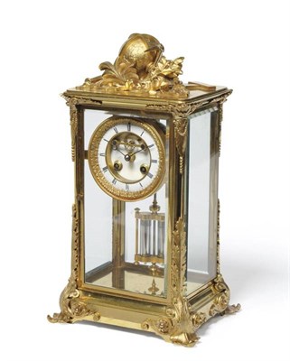 Lot 1034 - A French Gilt Brass Striking Four Glass Mantel Clock, circa 1890, surmounted by a globe, floral and