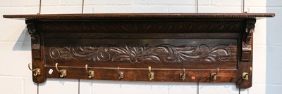 Lot 1431 - An early 20th century carved oak eight rack...