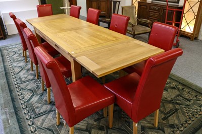 Lot 1288 - A modern golden oak draw leaf dining table,...