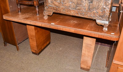 Lot 1423 - An Art Deco walnut dining table raised on twin...