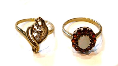 Lot 222 - An opal and garnet cluster ring, stamped '10K',...