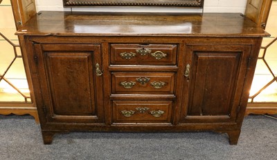 Lot 1293 - An 18th century panelled oak dresser base,...