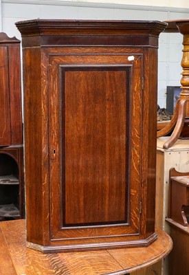 Lot 1330 - A George III crossbanded oak hanging corner...