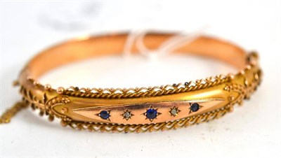 Lot 107 - A 9ct gold sapphire and diamond bangle