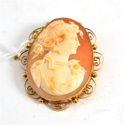 Lot 111 - A cameo brooch within a scroll frame