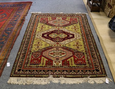 Lot 1110 - A Caucasian design rug, the olive green field...