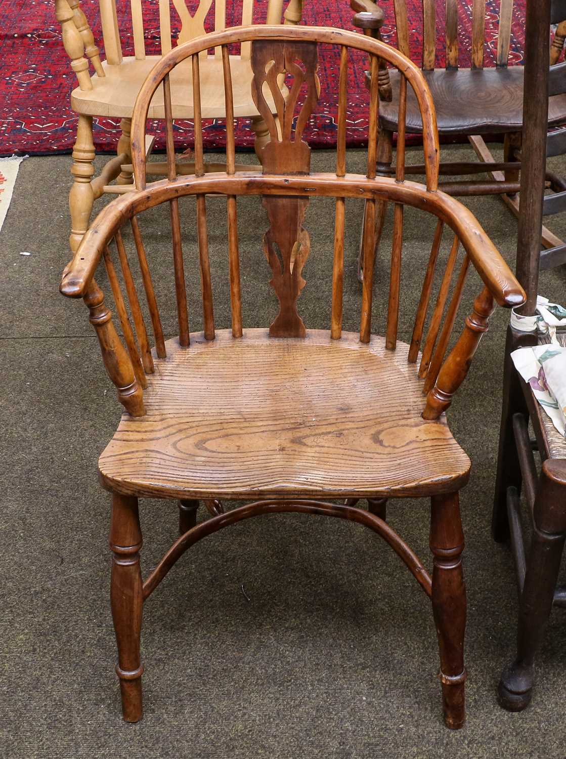 A Yew wood and elm Windsor chair with crinoline stretcher | Barnebys