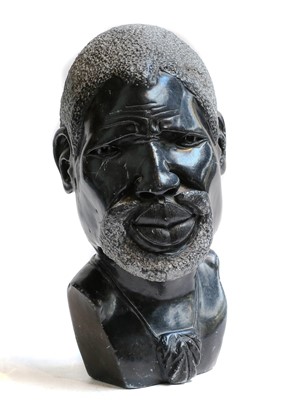 Lot 325 - An African carved marble bust of a bearded man,...