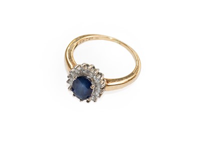 Lot 242 - A sapphire and diamond cluster ring, finger...