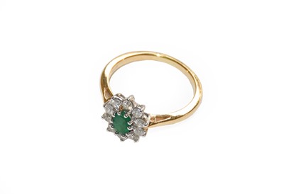 Lot 212 - An 18 carat gold emerald and diamond cluster...