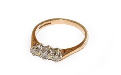 Lot 237 - A 9 carat gold diamond three stone ring,...
