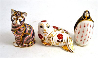 Lot 178 - Three Royal Crown Derby paperweights: A seal, a penguin and a cat (3)
