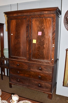 Lot 1397 - A Regency mahogany linen press with rosewood...