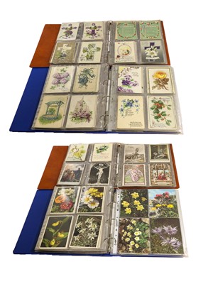 Lot 219 - Four albums containing a wide mix of postcards,...