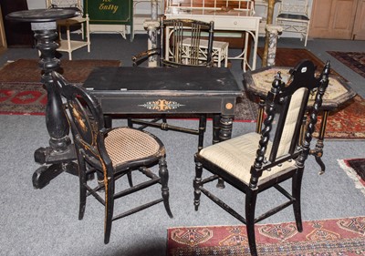 Lot 1254 - ~ A parcel-gilt ebonised table with ring...