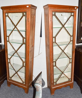 Lot 1291 - A pair of tall slender glazed pine cabinets...