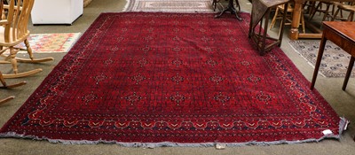 Lot 1096 - Afghan Turkmen carpet, the claret field with...