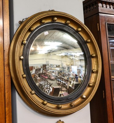 Lot 1319 - A Regency gilt framed convex mirror with...