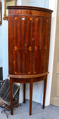 Lot 1244 - A George III bow fronted corner cupboard on...