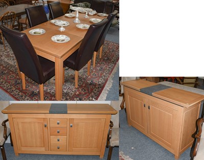 Lot 1112 - A modern light oak dining suite, comprising,...