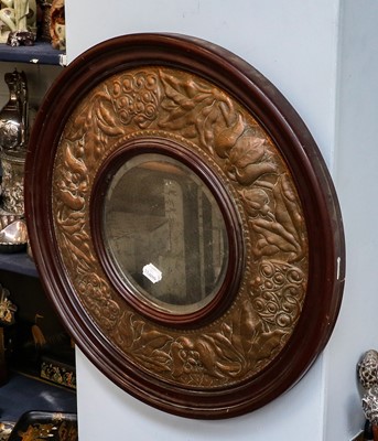 Lot 375 - ~An Arts & Crafts circular wall mirror, with...