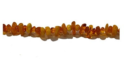 Lot 244 - An amber bead necklace, formed of irregular...