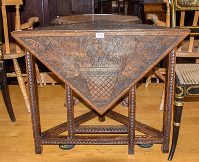 Lot 1314 - A late 19th century oak corner drop leaf table,...