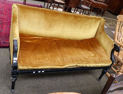 Lot 1203 - A Regency ebonised parcel gilt sofa, with leaf...