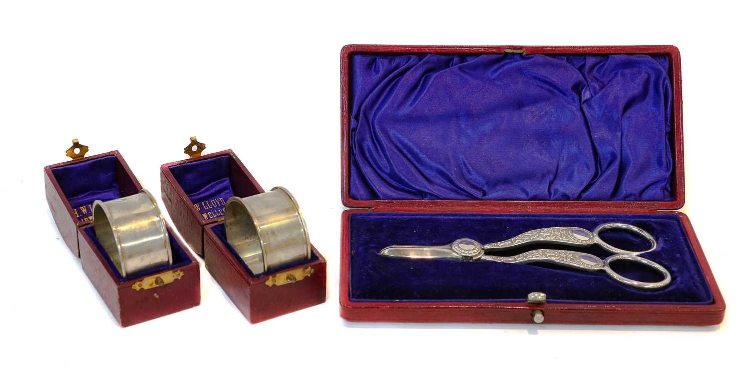 Lot 48 - A cased pair of silver grape scissors and...