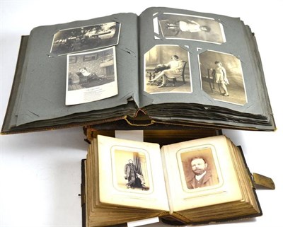 Lot 257 - An album of early postcards together with a musical photograph album (a.f.) and a smaller album...