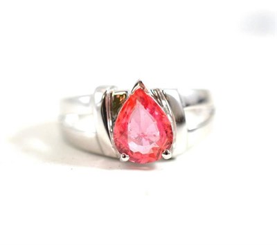 Lot 262 - An 18ct white gold padparadscha ring, the pear cut sapphire in a claw setting, to chunky...