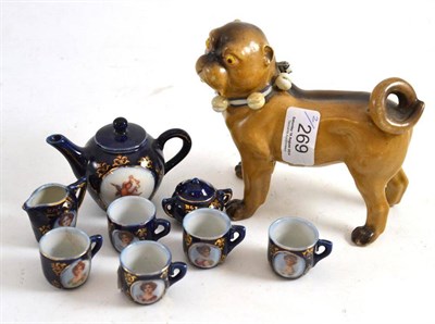 Lot 269 - A German porcelain pug and a miniature doll's tea set