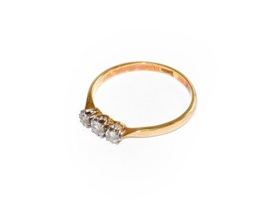 Lot 243 - A diamond three stone ring, stamped '18CT',...