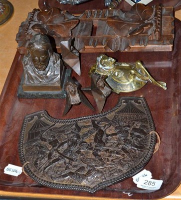 Lot 285 - A carved oak book trough, a shield shape embossed metal plaque,  bronze portrait bust, three bronze