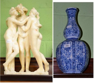 Lot 308 - Early 20th century blue and white tin glaze gourd vase and alabaster group of the Three Graces (2)