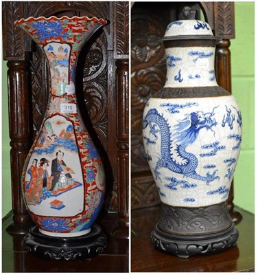 Lot 310 - Japanese blue and white pottery baluster vase and cover and a Japanese vase with flared rim,...