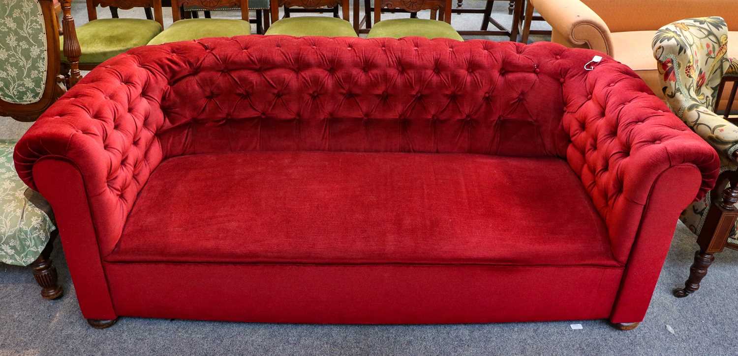 Lot 1205 - A red velvet upholstered Chesterfield sofa, 192cm