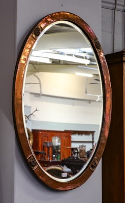 Lot 1259 - An Arts & Crafts copper framed oval wall...