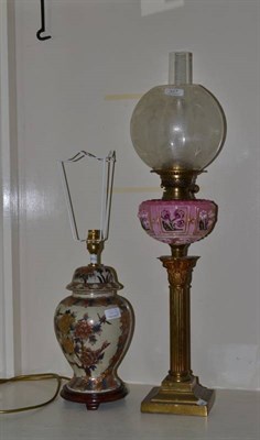 Lot 327 - Brass column oil lamp with pink glass oil well and glass shade and a modern table lamp (2)