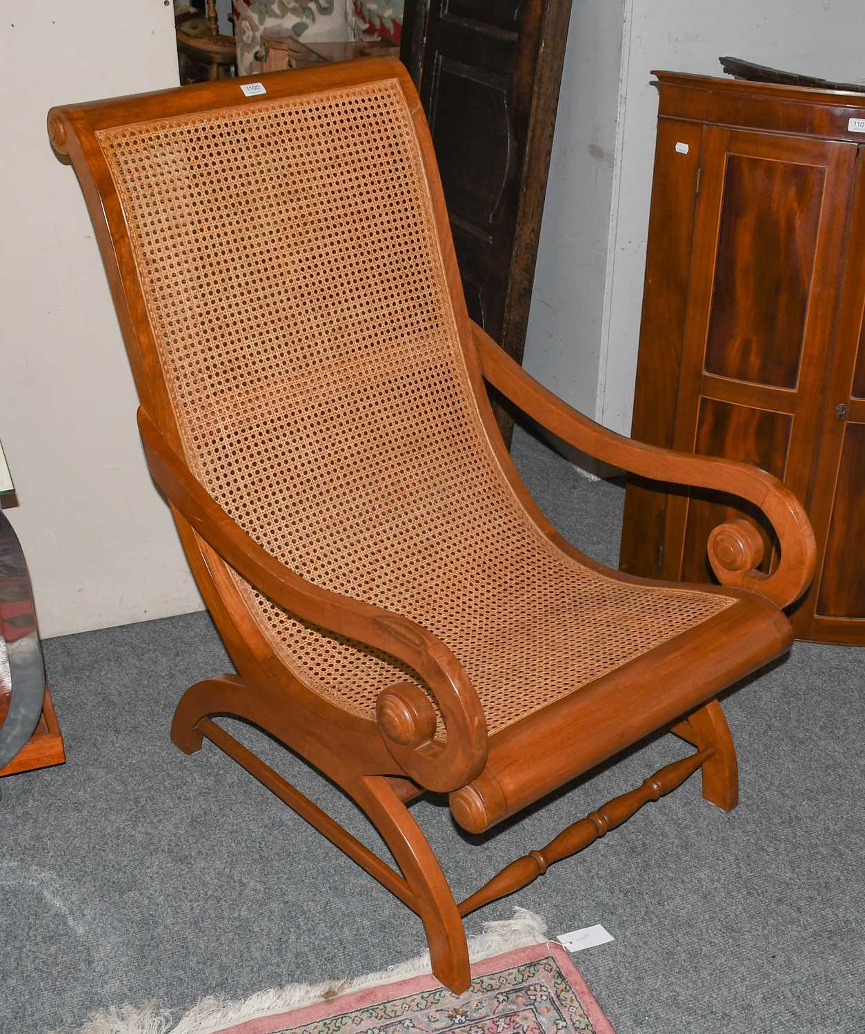 Lot 1100 - A modern plantation style armchair with caned...