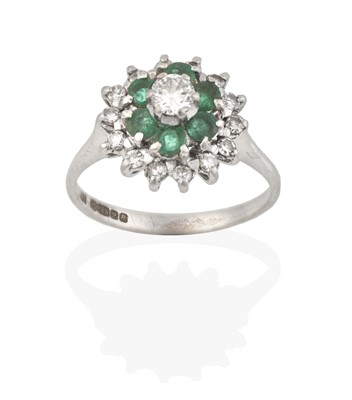 Lot 2414 - An 18 Carat White Gold Emerald and Diamond Cluster Ring