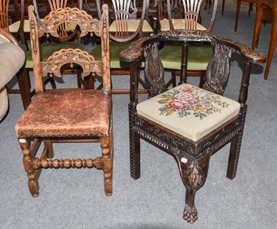Lot 1202 - A carved oak corner chair decorated with a...