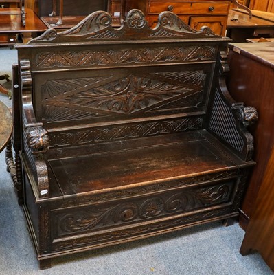 Lot 1186 - A 1920's carved oak box settle, 120cm by 43cm...