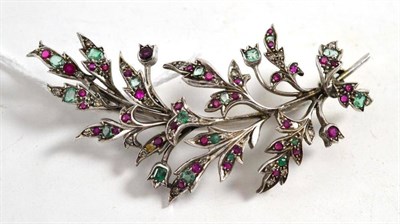 Lot 370 - A floral spray brooch, inset with eight-cut diamonds, various emeralds and rubies, in white...