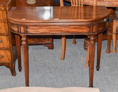 Lot 1190 - A mahogany foldover card table on tapering...