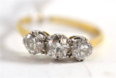 Lot 377 - A diamond three stone ring, the brilliant cut diamonds in white claw settings, to a yellow...